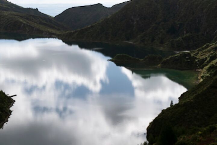 Clouds mirrored in a still crater lake