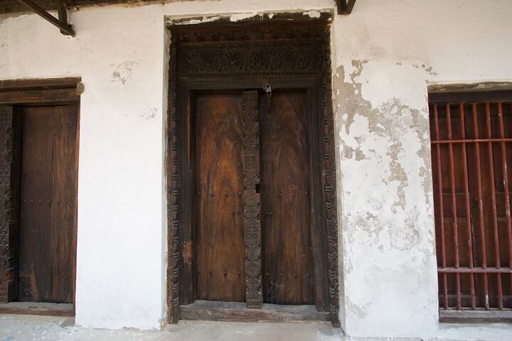 Carved wooden door in a weathered wall