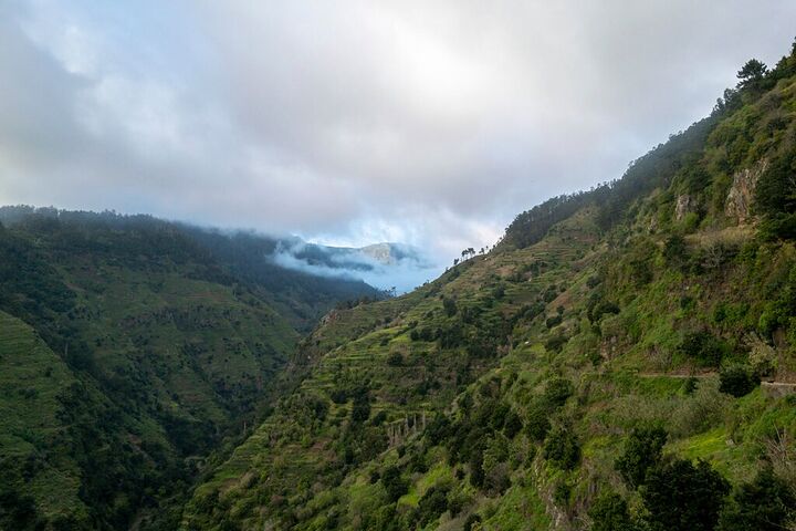 Cloud spilling into a green valley