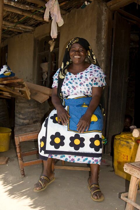 Smiling woman seated in a doorway