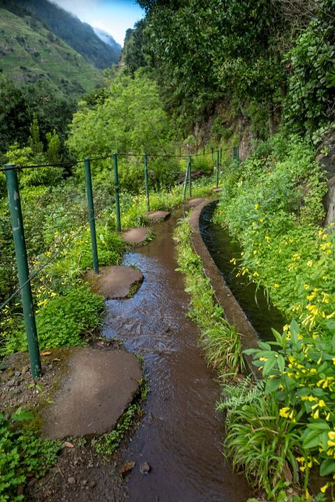 Levada irrigation path through green hills