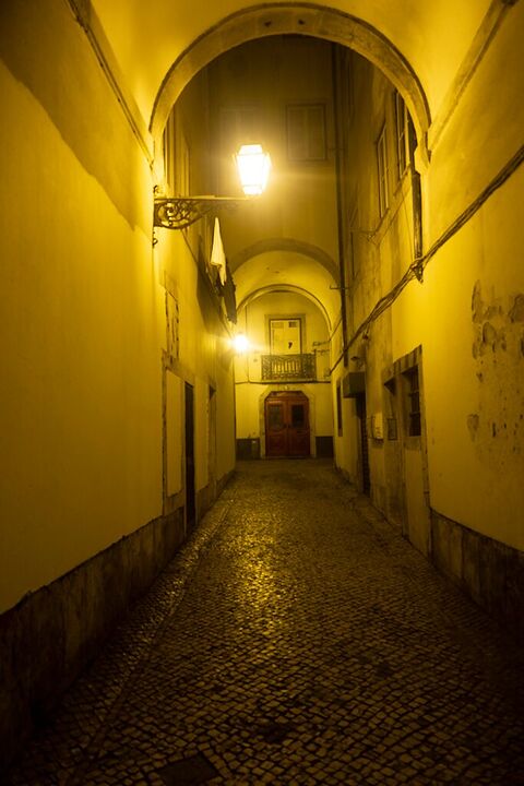 Lamp-lit vaulted passage in yellow light