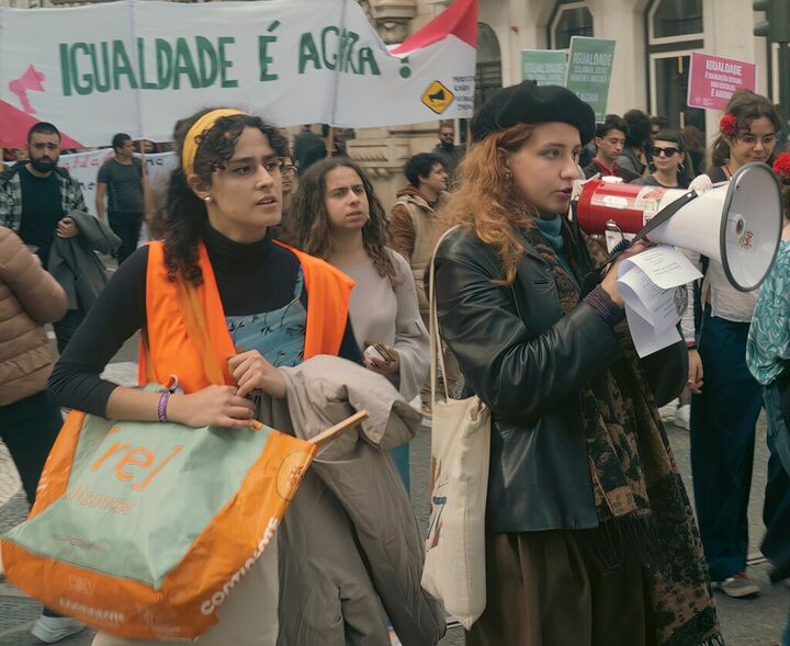 Young women with a megaphone at a march for equality