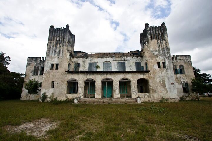A weathered old palace under a cloudy sky