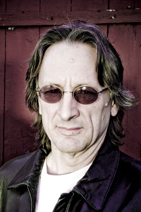 Musician with long hair and round sunglasses