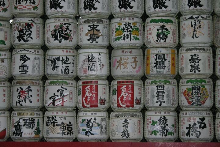 Wall of decorated sake barrels at a shrine