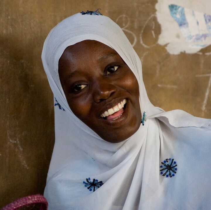 Smiling woman in a white headscarf