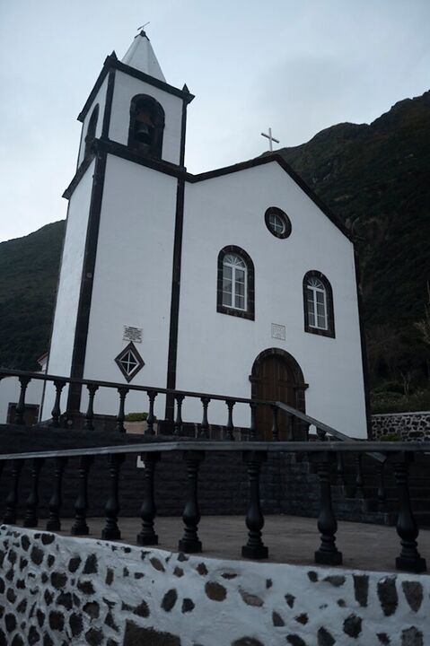 White chapel against a dark hillside